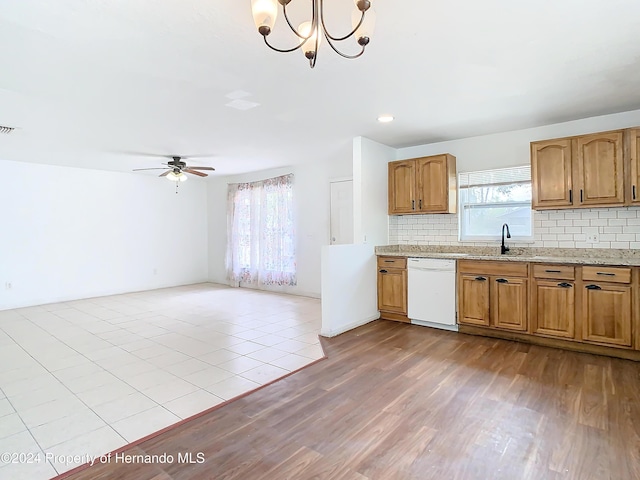 kitchen with dishwasher, sink, tasteful backsplash, light hardwood / wood-style floors, and ceiling fan with notable chandelier