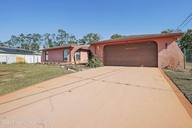 view of front of property with a garage and a front yard