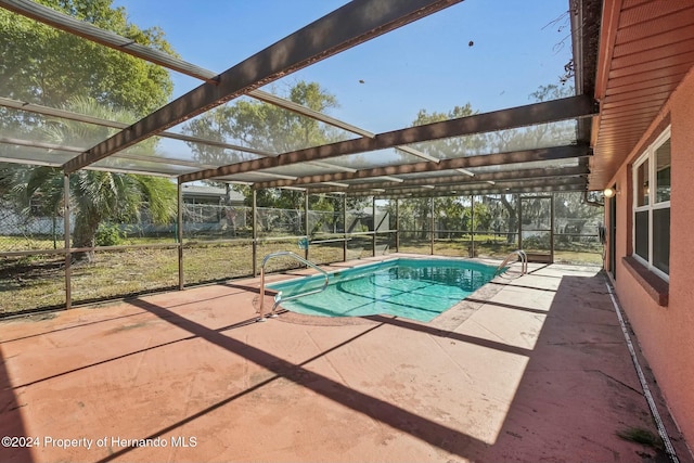 view of pool with a lanai and a patio area