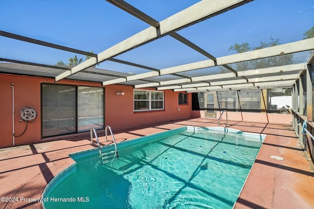 view of pool featuring a lanai and a patio