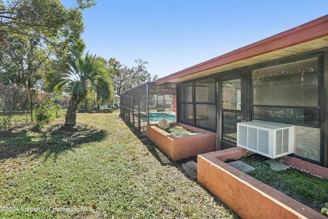 view of yard with cooling unit and glass enclosure