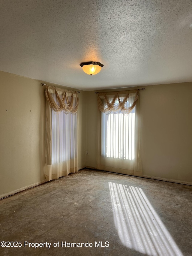 spare room with a textured ceiling