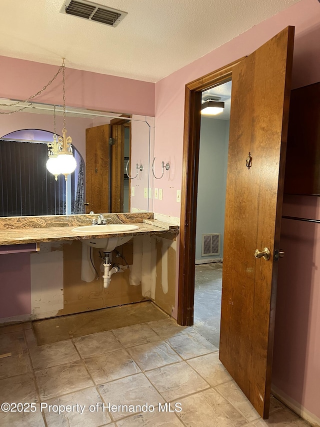 bathroom with a textured ceiling