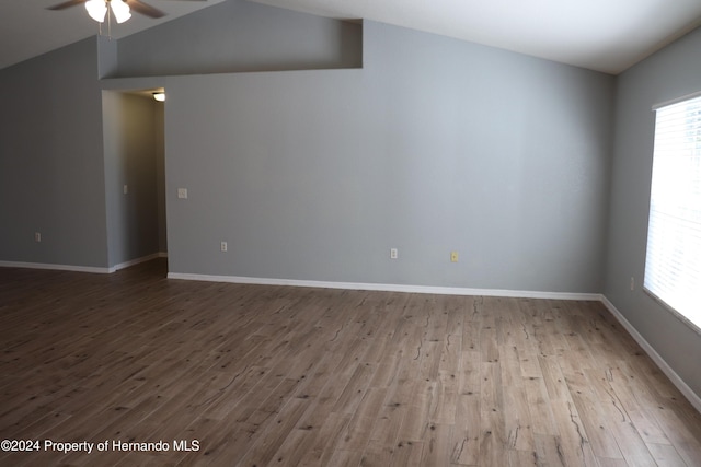 unfurnished room featuring ceiling fan, light hardwood / wood-style floors, and vaulted ceiling