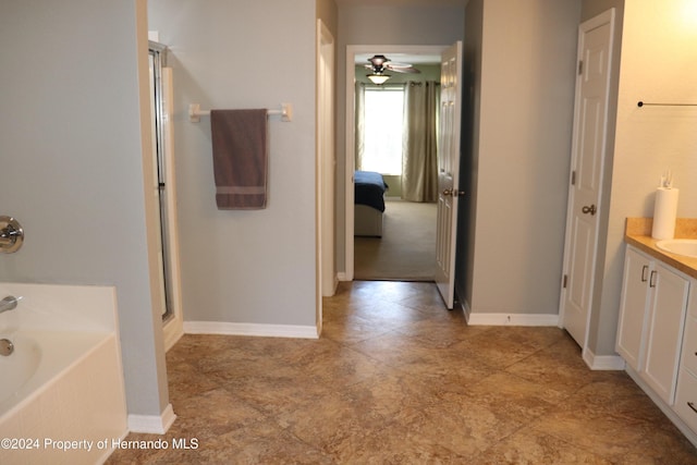 bathroom featuring vanity, ceiling fan, and independent shower and bath