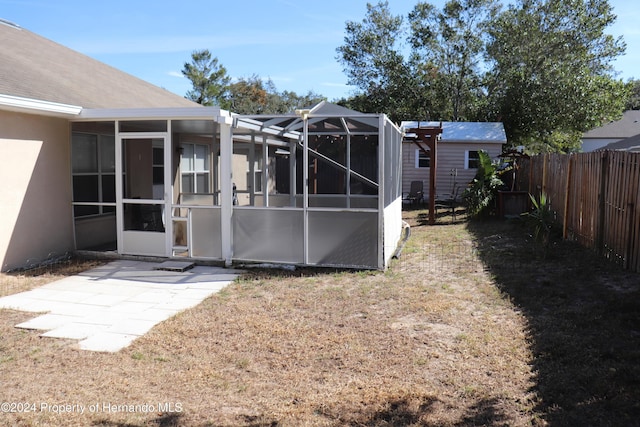 view of yard with a lanai and a patio