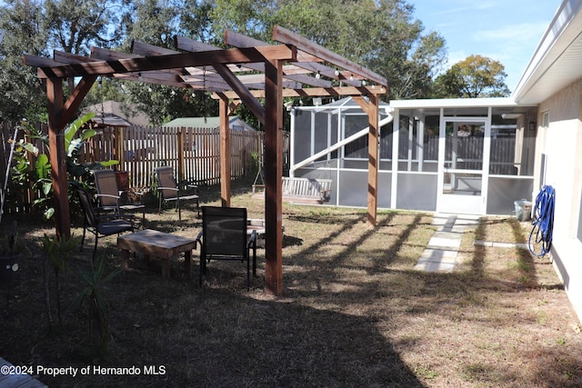 view of yard featuring a pergola and a sunroom