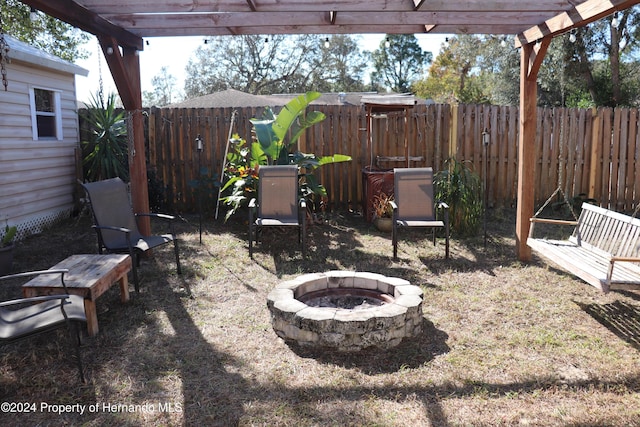 view of patio / terrace with a pergola and an outdoor fire pit