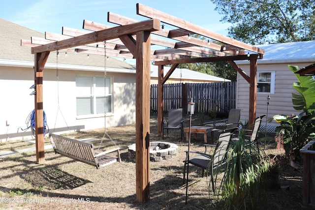 view of patio with a pergola and a fire pit