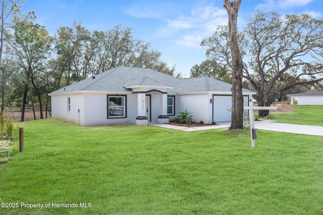 view of front of house featuring a garage, a front yard, and concrete driveway