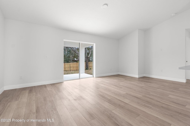 empty room featuring light wood-style flooring and baseboards