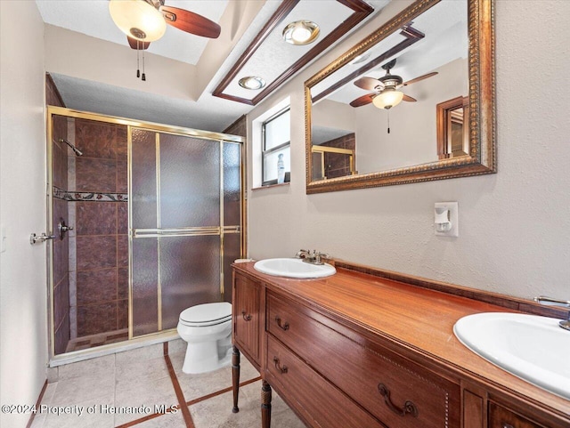 bathroom with tile patterned flooring, vanity, toilet, and a shower with door