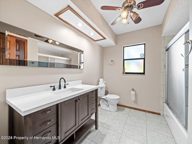 full bathroom with bath / shower combo with glass door, vanity, ceiling fan, tile patterned flooring, and toilet