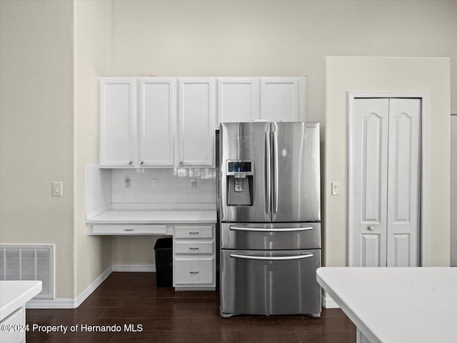 kitchen featuring white cabinets, stainless steel fridge with ice dispenser, decorative backsplash, and dark wood-type flooring