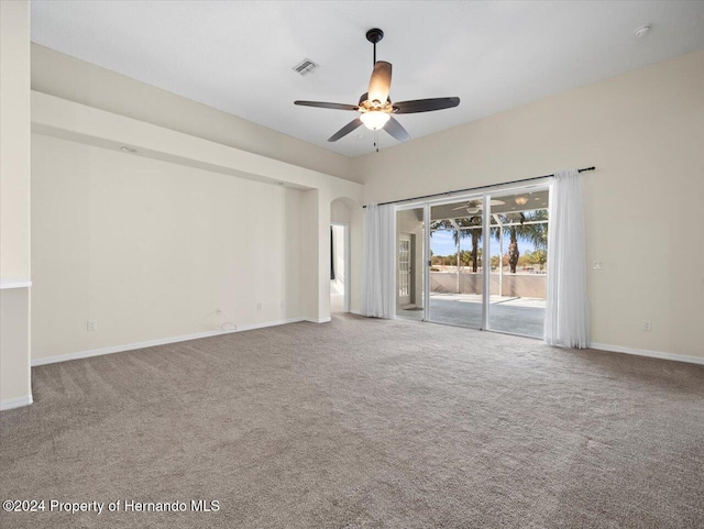 carpeted spare room with ceiling fan