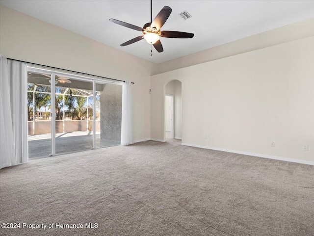 carpeted spare room featuring ceiling fan