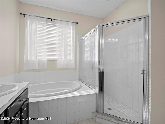 bathroom with vanity, independent shower and bath, and lofted ceiling