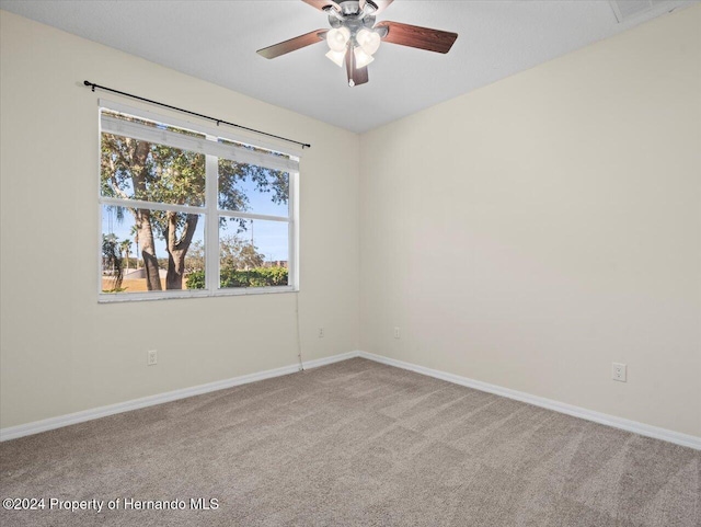 unfurnished room with ceiling fan and light colored carpet