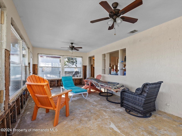 sunroom / solarium featuring ceiling fan