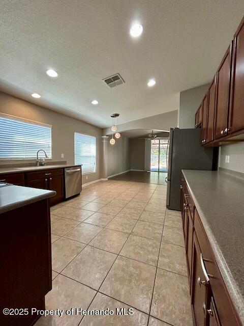 kitchen with a wealth of natural light, visible vents, appliances with stainless steel finishes, and a sink