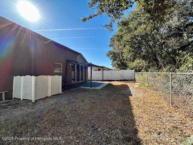 view of yard with a patio area and a fenced backyard