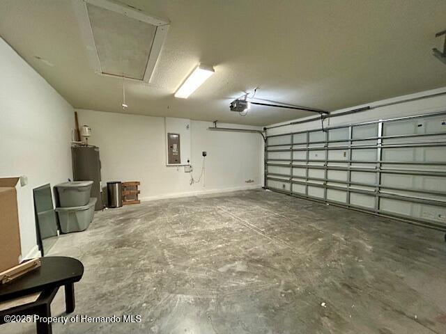 garage with electric panel, water heater, and a garage door opener