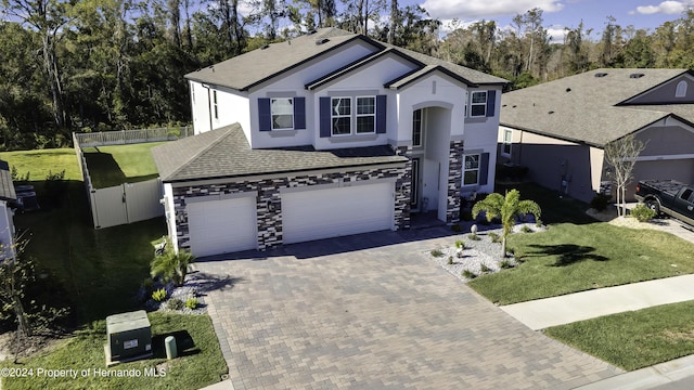 front of property featuring a front yard and a garage