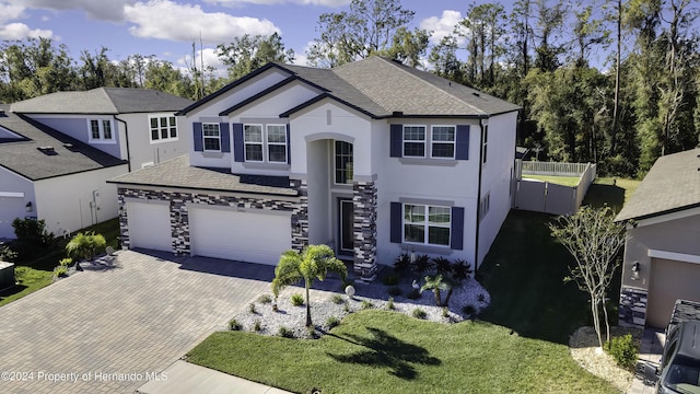 front facade featuring a garage and a front lawn