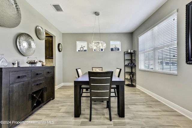 dining space featuring a notable chandelier and light hardwood / wood-style flooring