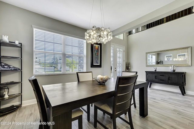 dining room featuring a chandelier and light wood-type flooring