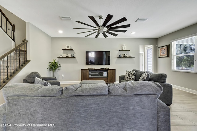 living room featuring ceiling fan and light wood-type flooring