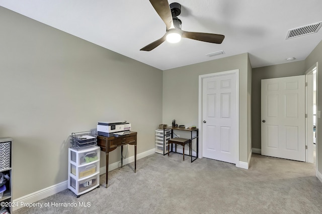 office area featuring light carpet and ceiling fan