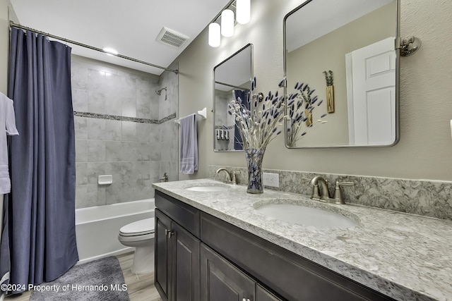 full bathroom featuring hardwood / wood-style floors, vanity, shower / bath combination with curtain, and toilet