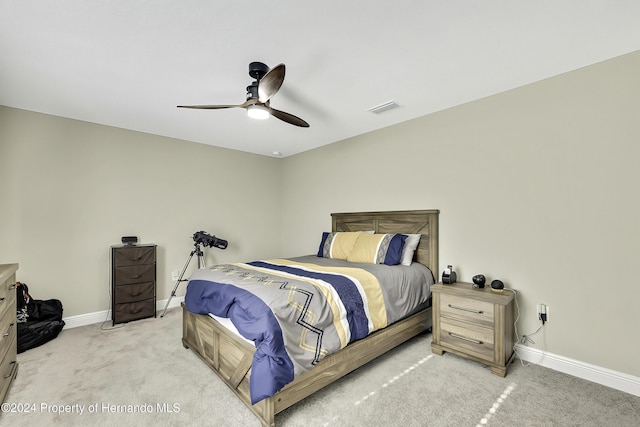 bedroom with ceiling fan and light carpet