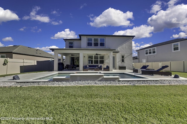 rear view of house with outdoor lounge area, a fenced in pool, ceiling fan, and a patio area