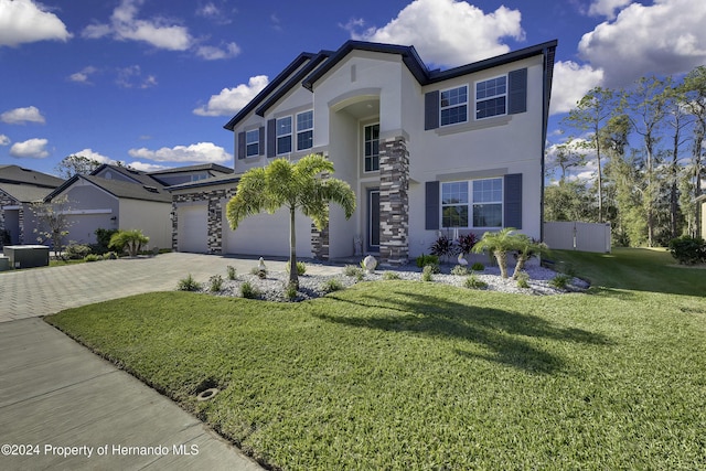 view of front of home featuring a garage and a front yard