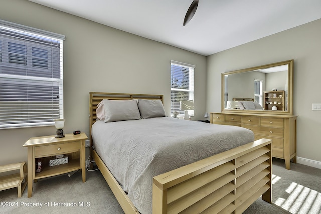 bedroom with ceiling fan and light colored carpet