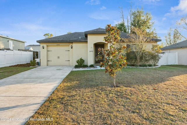 view of front of property featuring a garage and a front lawn