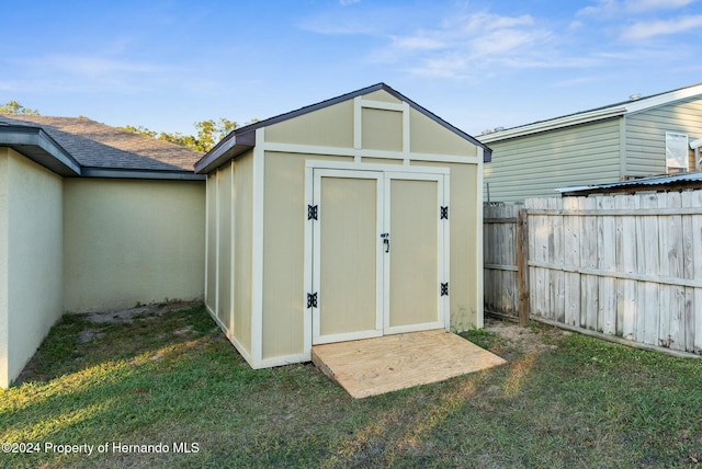 view of outbuilding with a lawn