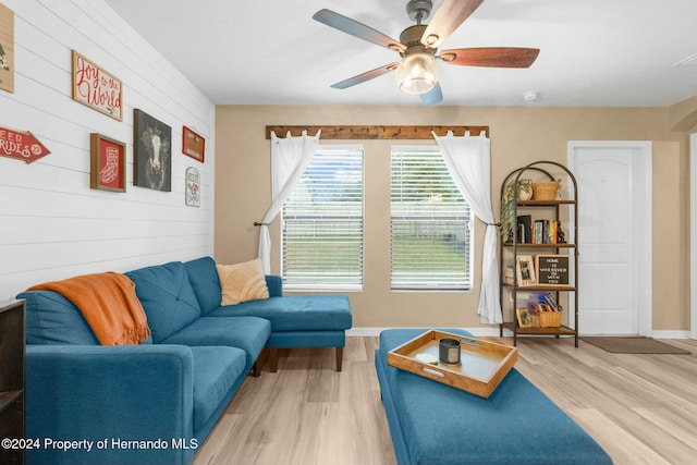 living room with ceiling fan and light hardwood / wood-style flooring