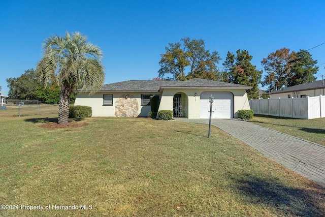 view of front facade with a front yard and a garage