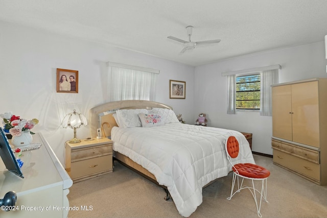 bedroom with light colored carpet and ceiling fan