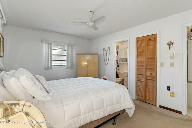 bedroom with connected bathroom, ceiling fan, and light colored carpet