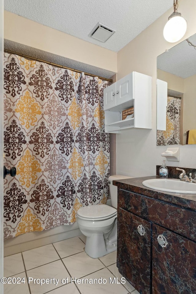 full bathroom featuring vanity, tile patterned flooring, toilet, a textured ceiling, and shower / tub combo