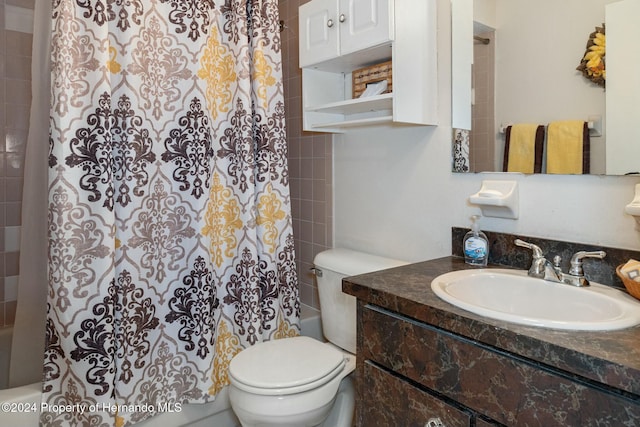 full bathroom with shower / bath combo, vanity, and toilet