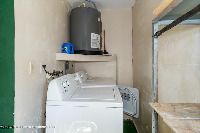 laundry area with washer and dryer and water heater