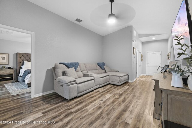 living room featuring ceiling fan and hardwood / wood-style flooring