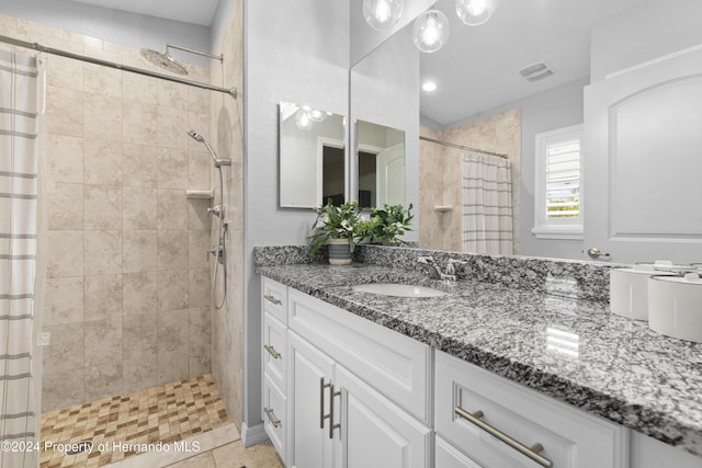 bathroom featuring tile patterned flooring, vanity, and a shower with shower curtain