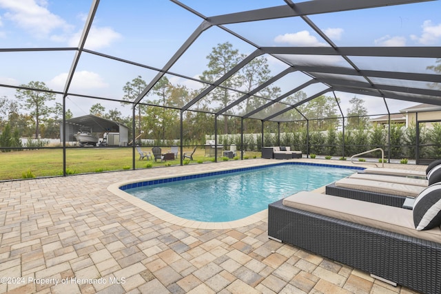 view of swimming pool featuring a patio, a lanai, and a lawn