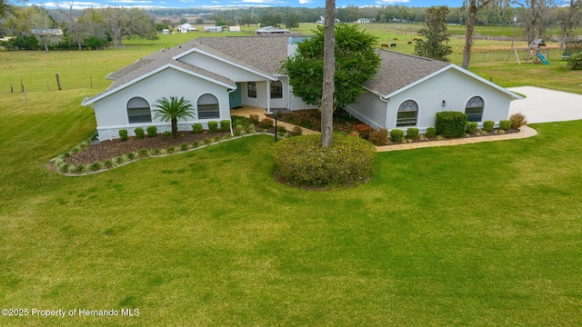 ranch-style home featuring a front yard and a rural view